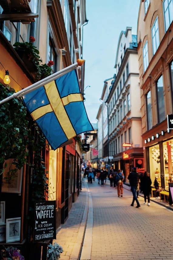 most accessible cities - The Most Accessible Cities in the World A Swedish flag among buildings in Stockholm.