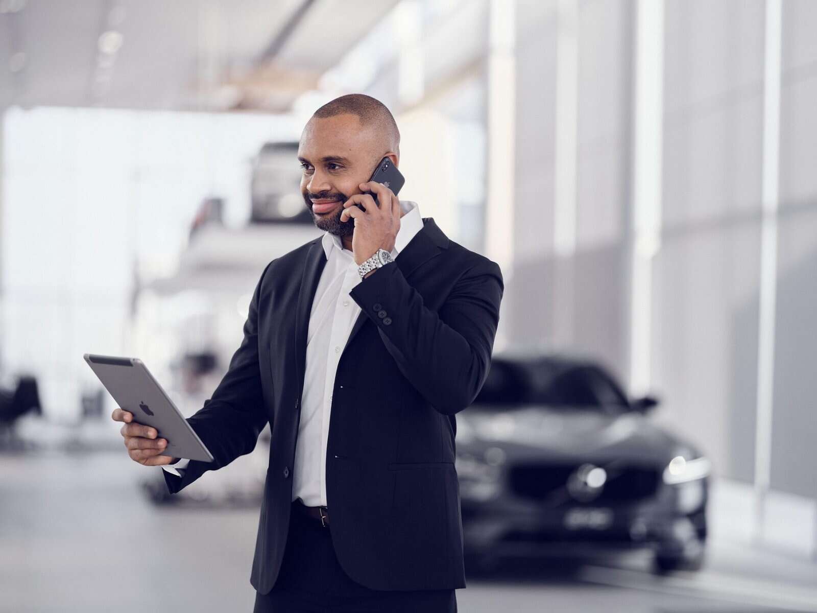 - The Rise of Premium Chauffeur Services in a Post-Rideshare Era Chauffeur checking the flight arrival times.