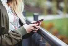 A woman on a smartphone texting using international data roaming