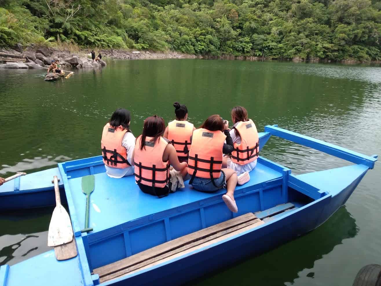 things to do in dumaguete - Things to Do in Dumaguete: A Traveler’s Guide to the City of Gentle People Adventurers on a boat at the Twin Lakes of Balinsasayao.
