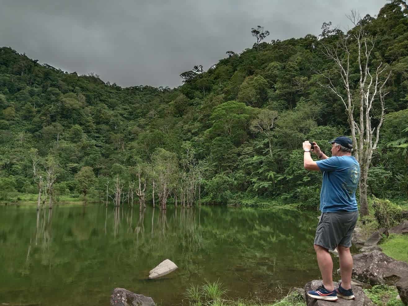 things to do in dumaguete - Things to Do in Dumaguete: A Traveler’s Guide to the City of Gentle People A man taking a photo at the Twin Lakes of Balinsasayao.